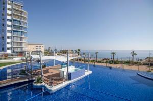 a swimming pool with the ocean in the background at Sea Senses by Mar Holidays in Torrevieja