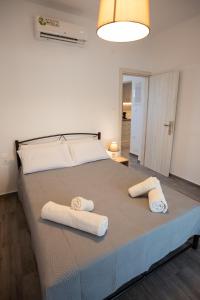 a bedroom with a large bed with towels on it at Celine House in Volos