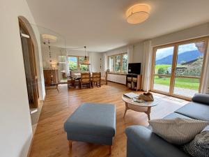 a living room with a blue couch and a table at FeWo Zuhause Ruhpolding in Ruhpolding