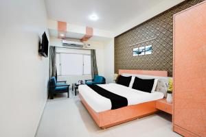 a bedroom with a king sized bed and a window at Super Townhouse Maithli Marg Sector 55 Formerly Red Roof in Noida +23 photos