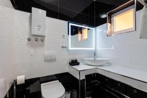 a white bathroom with a sink and a toilet at Bayview Villa by Pag tours in Pag