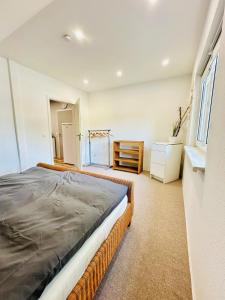 a bedroom with a large bed and a window at Ferienwohnung Prieros am Langer See mit Klima in Heidesee +14 photos