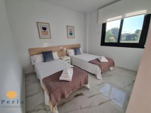 ein Schlafzimmer mit zwei Betten und einem Fenster in der Unterkunft Perla Holidays - Stunning apartment in Los Altos in Orihuela + 14 Fotos