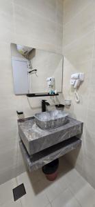 a bathroom with a sink and a mirror at Luxury Furnished Apartment in Salalah Center in Salalah +12 photos
