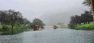 three boats in a river with people on them at Luxury Furnished Apartment in Salalah Center in Salalah