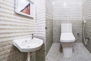 a bathroom with a white sink and a toilet at Super Hotel O Adibatla near TCS in Hyderabad
