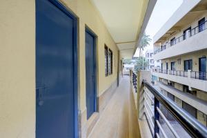 a blue door on the side of a building at Hotel O Talawade IT Park Formerly AR Rooms in Dehu