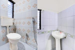 a bathroom with a toilet and a sink at Hotel O Talawade IT Park Formerly AR Rooms in Dehu