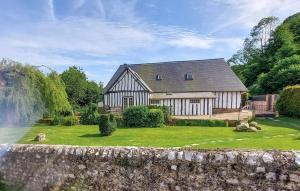 a house with a waterfall in front of a yard at Maison familiale à Vittefleur avec jardin spacieux 140 m² 8 pers. in Vittefleur