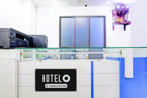 a hotel sign on a glass counter in a room at Super Hotel O Santragachi Junction Formerly Hotel Shubra in Kolkata