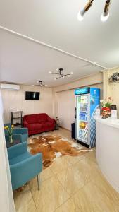 a living room with a red couch and a refrigerator at Baiterek Premium in Astana