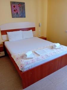 a bed in a room with two towels on it at Apartmani Medijana Niš in Niš