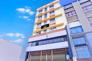 a tall apartment building with colorful windows at Super Collection O Katraj Near KK Market in Pune