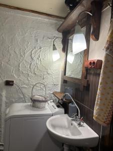 a small bathroom with a sink and a sink at BerryWood in Verkhnyaya Stynava +24 photos
