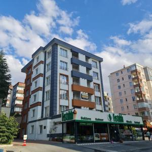 a tall building with a store in front of it at ARGEUS PRESTİJ in Kayseri