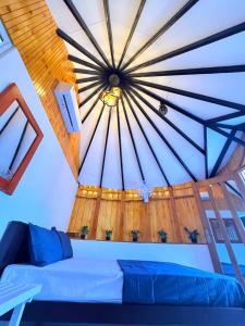 a room with a blue couch and a ceiling at Tribal Village in Trincomalee +18 photos