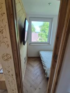 En eller flere senge i et værelse på Apartament pod kopieńcem