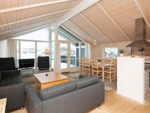 a living room with a couch and a table at Modern Beach Retreat - By Traum Ferienwohnungen in Løkken