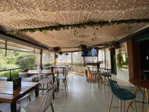 a restaurant with tables and chairs in a room at Cozy & Modern One Bedroom Opposite Garden City Mall in Nairobi