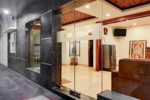 a glass walled entrance to a versace store at Super Townhouse Arcot Road Near Kauvery hospital in Chennai