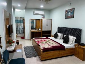 a bedroom with a large bed in a room at Hotel Priyanka in Raisen