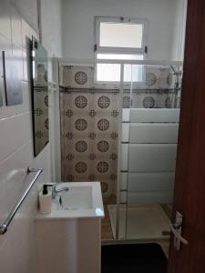 a bathroom with a sink and a shower at Porto Santo Sea View by Mth in Porto Santo +11 photos