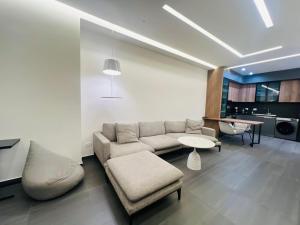 a living room with a couch and a table at Stylish 2BR Apartment with Balcony by Republic Square - City Center I Стильные апартаменты с 2 спальнями и балконом у площади Республики-Центр Города in Yerevan