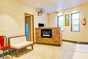 a waiting room with a chair and a counter at Super Collection O Pune Nagar Road Viman Nagar Formerly Ananta Sagar in Pune