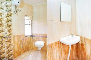 a bathroom with a sink and a toilet and a mirror at Super Collection O Pune Nagar Road Viman Nagar Formerly Ananta Sagar in Pune