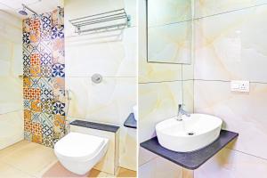 a bathroom with a white toilet and a sink at Super Collection O Pune Nagar Road Viman Nagar Formerly Ananta Sagar in Pune +59 photos