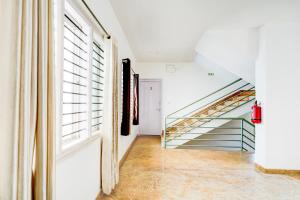a hallway with a staircase in a house at Super Collection O Rajkumar Road Formerly Stone Villa in Narasimharaja Puram