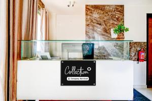 a glass counter with a sign on it at Super Collection O Rajkumar Road Formerly Stone Villa in Narasimharaja Puram