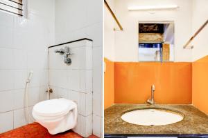 a bathroom with a toilet and a sink at Super Collection O Rajkumar Road Formerly Stone Villa in Narasimharaja Puram