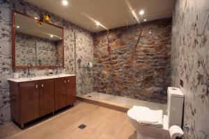 a bathroom with a toilet and a sink and a shower at NafplioBiofarms Country Apartments in Nafplio