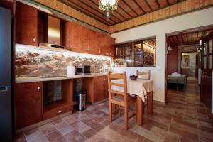 a kitchen with a table and a counter top at NafplioBiofarms Country Apartments in Nafplio +14 photos