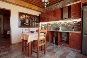 a kitchen with a table and a counter top at NafplioBiofarms Country Apartments in Nafplio