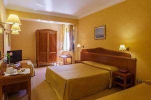 Postel nebo postele na pokoji v ubytování Hotel Conchiglia d'Oro