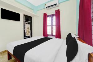 Katil atau katil-katil dalam bilik di Super Hotel O Kazhakuttam Vadakkumbhagam