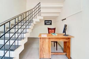 an office with a desk next to a staircase at Hotel O West Hill near Mietra Hospital in Calicut