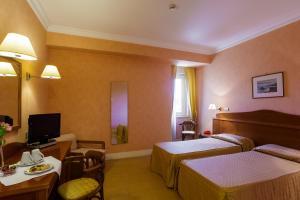 Postel nebo postele na pokoji v ubytování Hotel Conchiglia d'Oro
