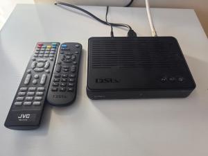 a desk with a remote control and a dsi router at Lofdal Guesthouse in Kimberley