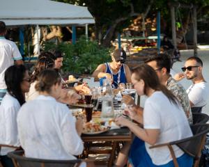 a group of people sitting at a table eating food at Kinan Retreat in Fulidhoo