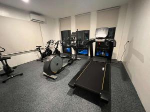 a gym with several treadmills and cardio machines at M&M Royal Oceancrest Mactan in Sudtungan