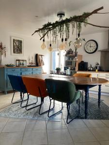 a kitchen with a wooden table and chairs at Ô Bord de Loire in Denée