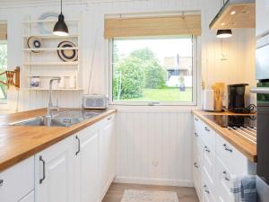 a kitchen with a sink and a window at 6 person holiday home in Karrebæksminde-By Traum in Karrebæksminde