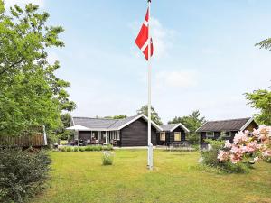 a canadian flag in front of a house at 4 star holiday home in Karrebæksminde in Karrebæksminde