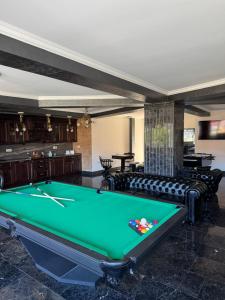 a pool table in a room with couches at Antique Charm Home SPA&FUN in Râşnov