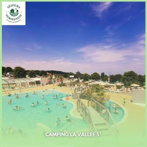 a group of people in a swimming pool at a resort at Houlgate - 254 - RARE VUE MER Magnifique Mobilhome 6 pers 3 chambres 2 SDB sur Camping 5 étoiles in Houlgate