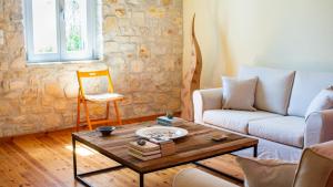 a living room with a couch and a coffee table at Dimitra's House in Aspro Chorio Paros
