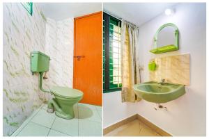a bathroom with a green toilet and a sink at Super Hotel O Vennala Near Palarivattom in Ernakulam